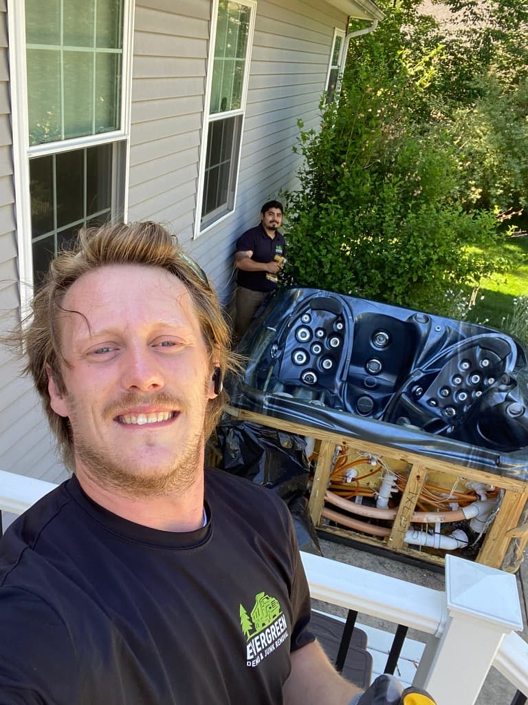 Austin and Marcos removing a hot tub